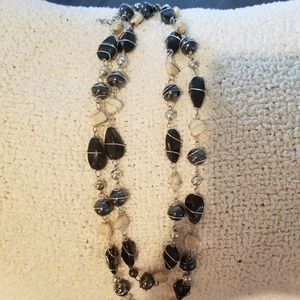 Extra long black cream and silver necklace